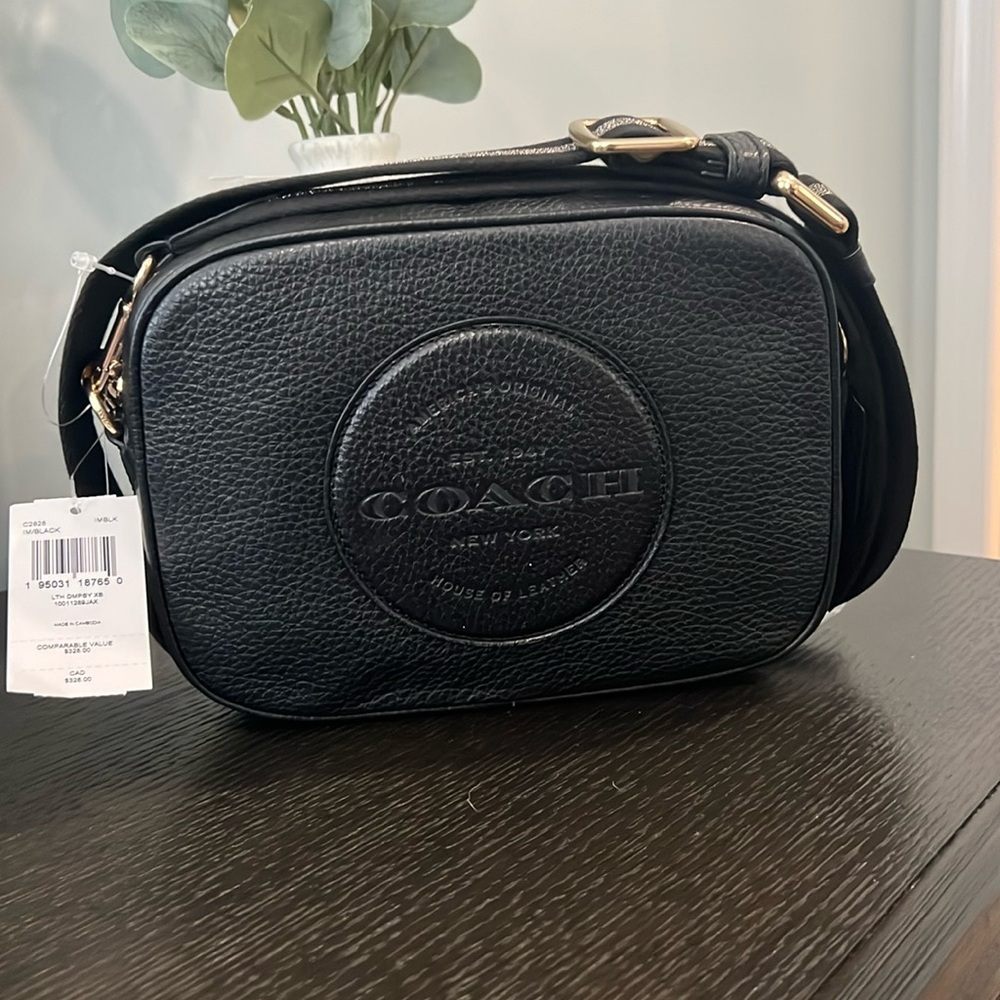 New with tags COACH black and silver crossbody bag with gold hardware.